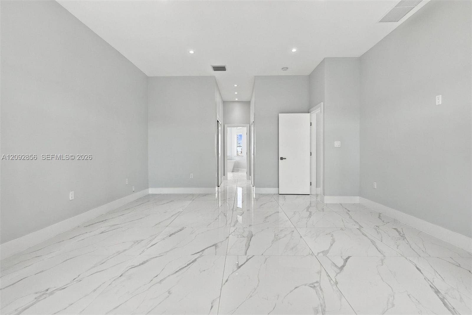 18919 SW 24th Street, #18919, Miramar, Miramar, FL 33029 Neutral interior featuring polished large-format tile flooring with veining, recessed lighting, and solid-core doors