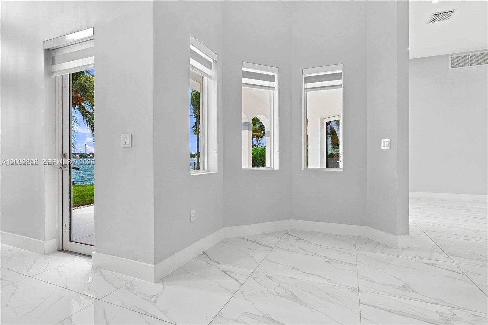 18919 SW 24th Street, #18919, Miramar, Miramar, FL 33029 Large-format white stone-finish flooring with grey veining, crisp white walls, and multiple floor-to-ceiling windows