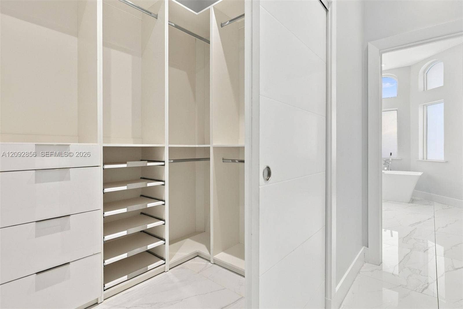 18919 SW 24th Street, #18919, Miramar, Miramar, FL 33029 Walk-in closet featuring custom white cabinetry, built-in shelving, multi-level hanging rods, and integrated drawers