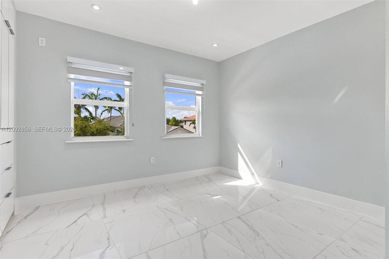18919 SW 24th Street, #18919, Miramar, Miramar, FL 33029 4th bedroom - 2nd floor - Neutral-toned interior featuring large-format tile flooring with veining, recessed lighting, and dual windows with roller shades