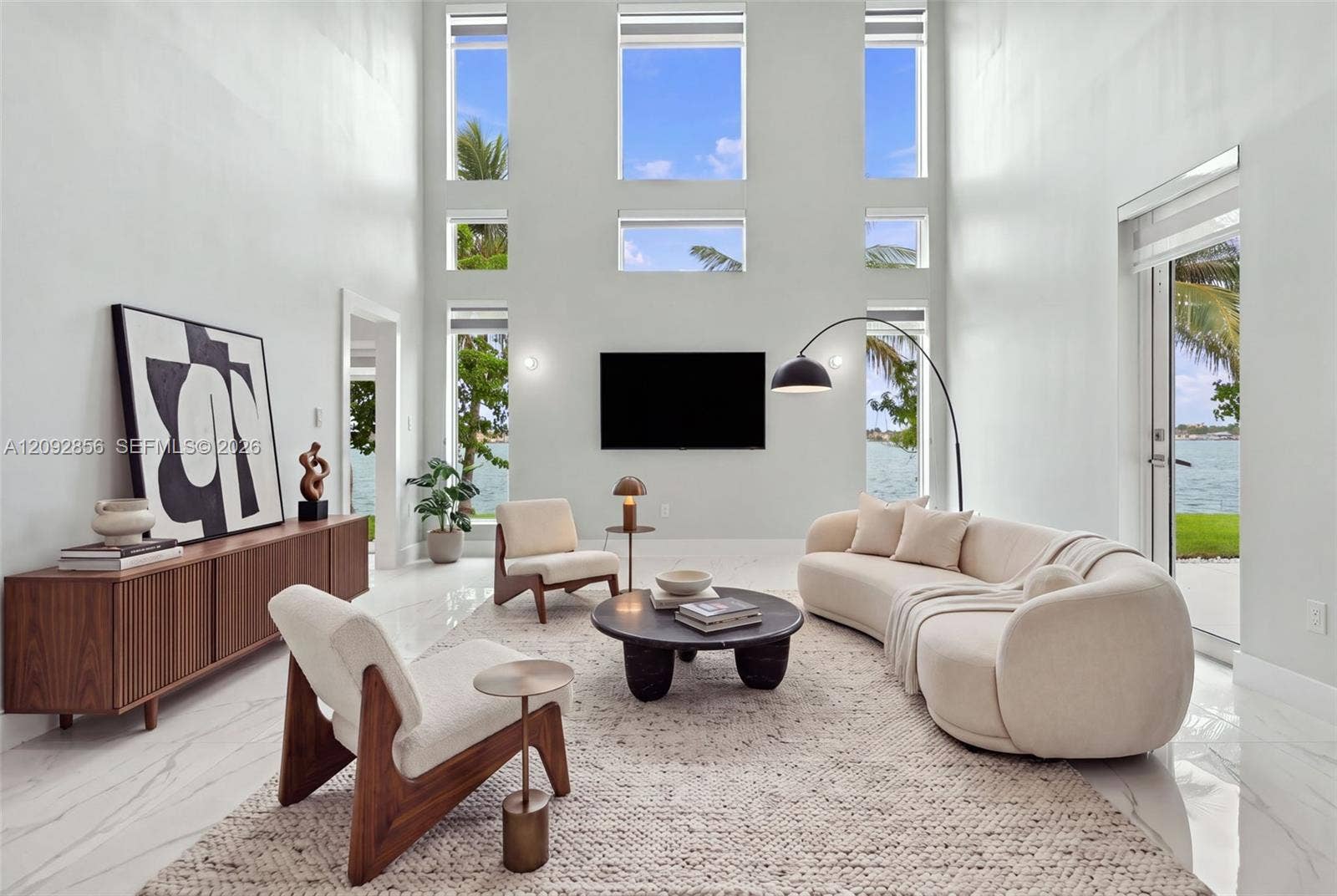 18919 SW 24th Street, #18919, Miramar, Miramar, FL 33029 Virtually staged - Double-height ceiling, floor-to-ceiling windows, polished stone-finish flooring, and glass door access