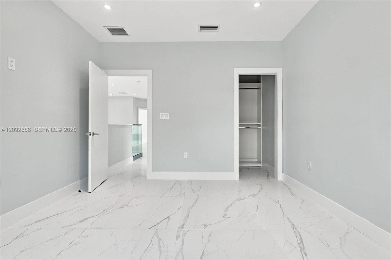 18919 SW 24th Street, #18919, Miramar, Miramar, FL 33029 3rd bedroom - 2nd floor - Interior space featuring large-format tile flooring with a neutral veined pattern, recessed ceiling lighting, and a built-in closet with integrated shelving