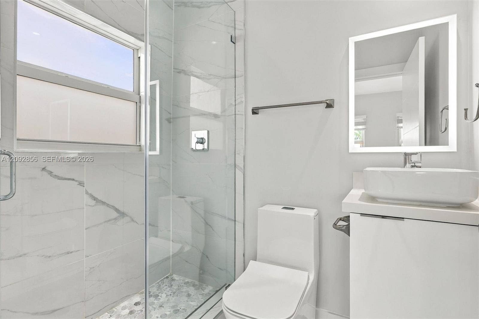 18919 SW 24th Street, #18919, Miramar, Miramar, FL 33029 4th bathroom (Insuite) Bathroom featuring a glass-enclosed shower with floor-to-ceiling stone-pattern tile, a floating vanity with a rectangular vessel sink, and an LED-backlit mirror