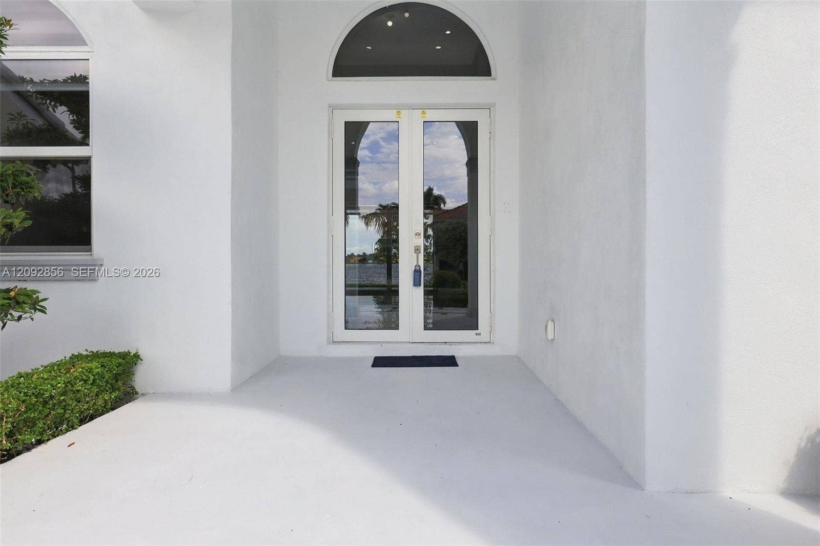 18919 SW 24th Street, #18919, Miramar, Miramar, FL 33029 Entrance featuring double glass doors, a semi-circular transom window, and a concrete patio