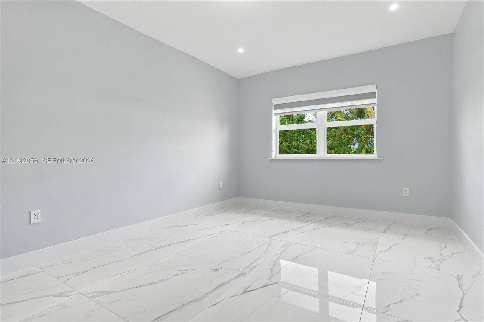 18919 SW 24th Street, #18919, Miramar, Miramar, FL 33029 3rd Bedroom - 2nd floor - Neutral interior room featuring polished stone-finish flooring with grey veining, recessed lighting, and a window with white trim