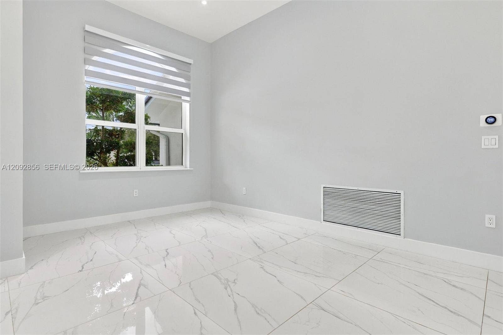18919 SW 24th Street, #18919, Miramar, Miramar, FL 33029 Large-format stone-finish floor tiles, neutral wall paint, and a window with a multi-layered roller shade