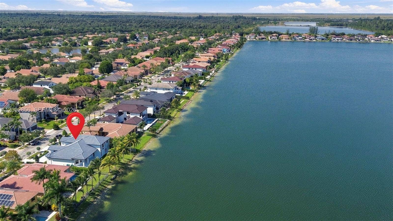 18919 SW 24th Street, #18919, Miramar, Miramar, FL 33029 Aerial perspective of waterfront property featuring direct lake access, tile roofing, and mature perimeter landscaping