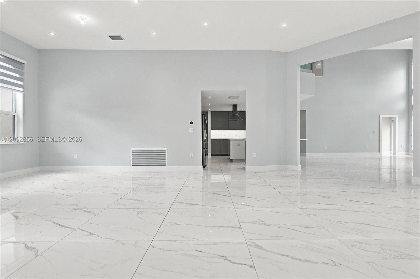 18919 SW 24th Street, #18919, Miramar, Miramar, FL 33029 Open-concept interior featuring large-format stone-patterned tile flooring, recessed ceiling lighting, and neutral wall tones