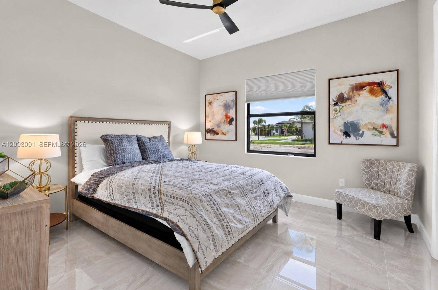 12688 SW Palmer Road, Port St Lucie, FL 34987 High ceilings featuring a matte black ceiling fan, neutral wall tones, large-format tile flooring, and a window with a roller shade