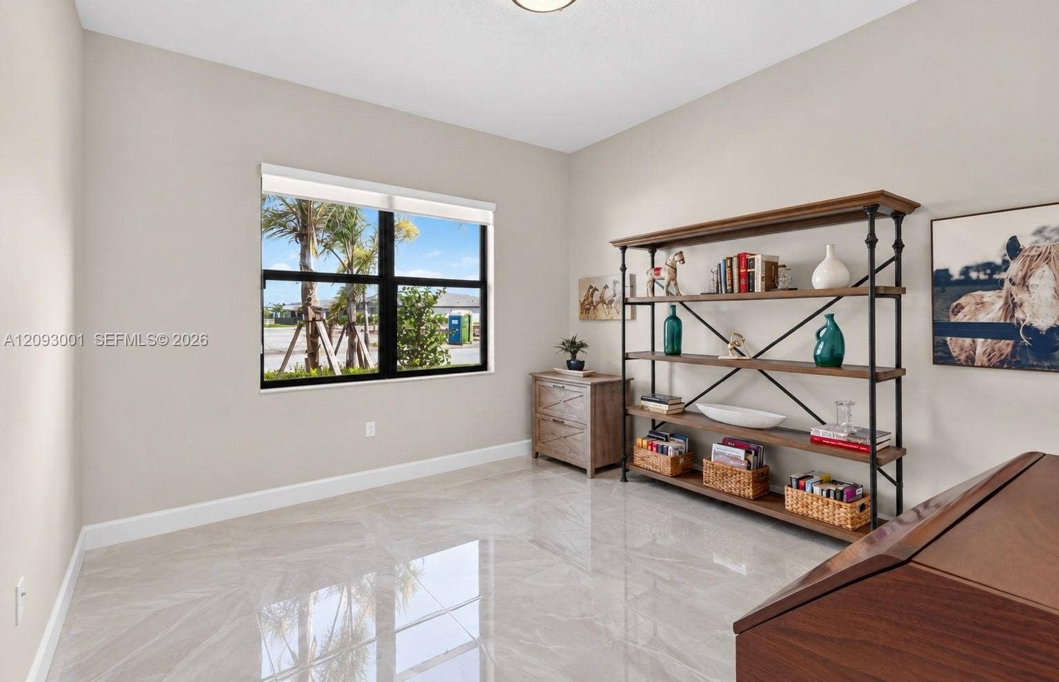 12688 SW Palmer Road, Port St Lucie, FL 34987 Interior room featuring high-gloss tile flooring, neutral wall paint, and a single-pane window with a black frame