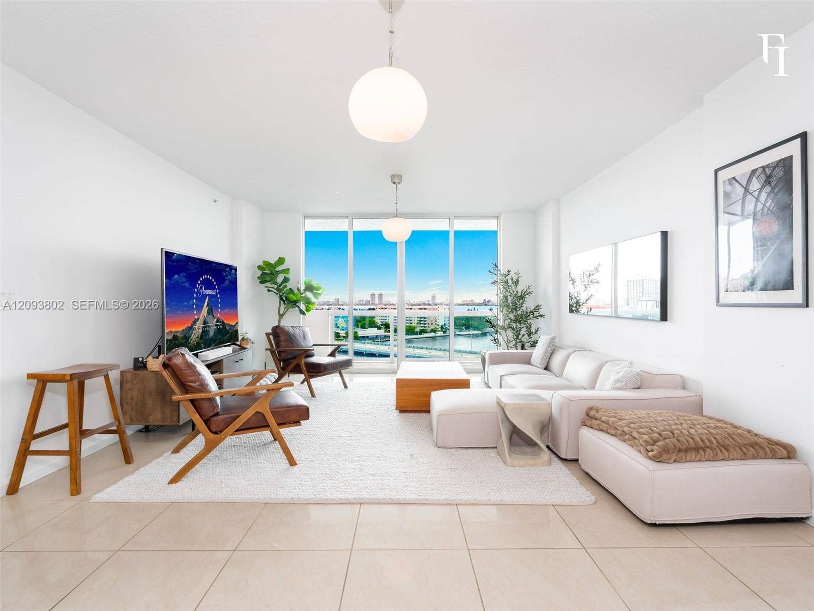 7910 Harbor Island Drive, #909, North Bay Village, North Bay Village, FL 33141 Open-concept living space featuring floor-to-ceiling glass windows, neutral tile flooring, and dual modern globe pendant light fixtures
