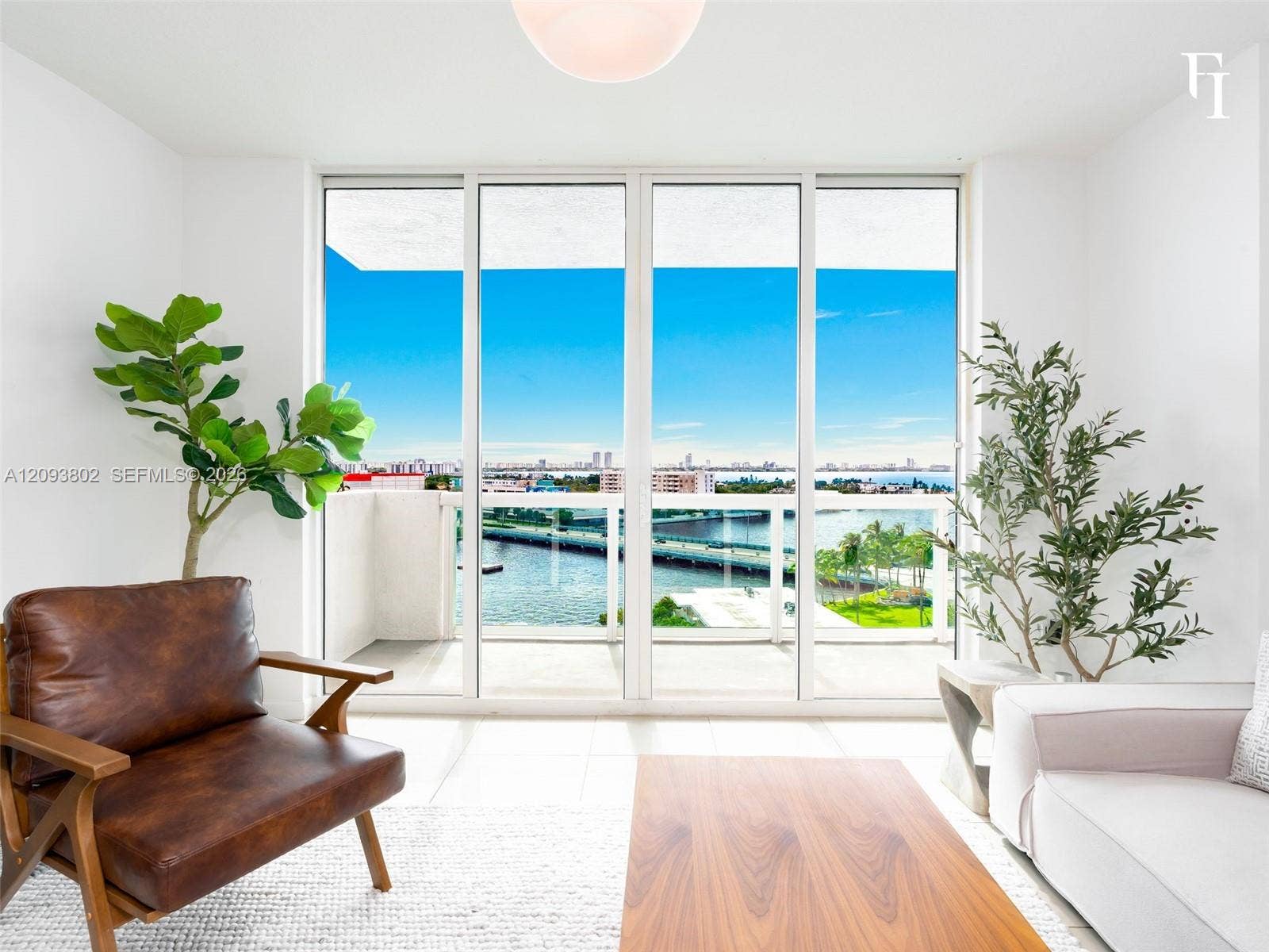 7910 Harbor Island Drive, #909, North Bay Village, North Bay Village, FL 33141 Floor-to-ceiling glass panel doors, white tiled flooring, and a glass-railed balcony featuring coastal water and cityscape scenery