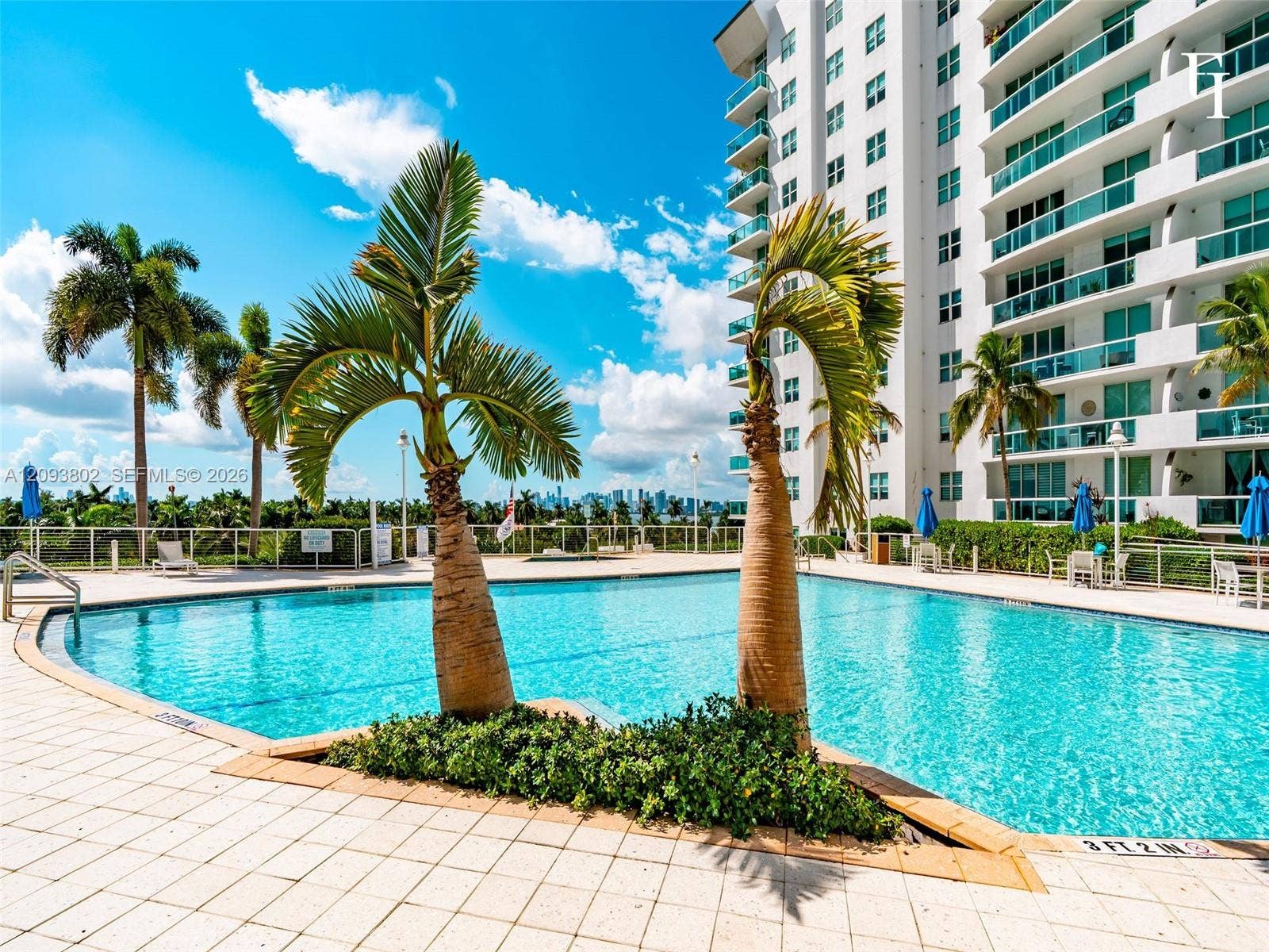 7910 Harbor Island Drive, #909, North Bay Village, North Bay Village, FL 33141 Swimming pool featuring a tiled deck, built-in landscaping, and transparent perimeter fencing
