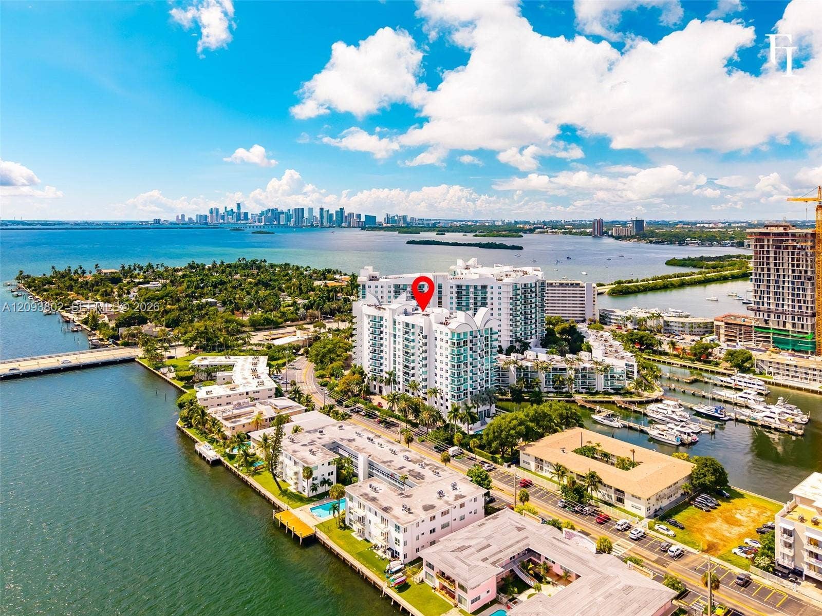 7910 Harbor Island Drive, #909, North Bay Village, North Bay Village, FL 33141 Aerial perspective of a high-rise condominium complex positioned on a waterfront peninsula, featuring direct water frontage and proximity to a marina