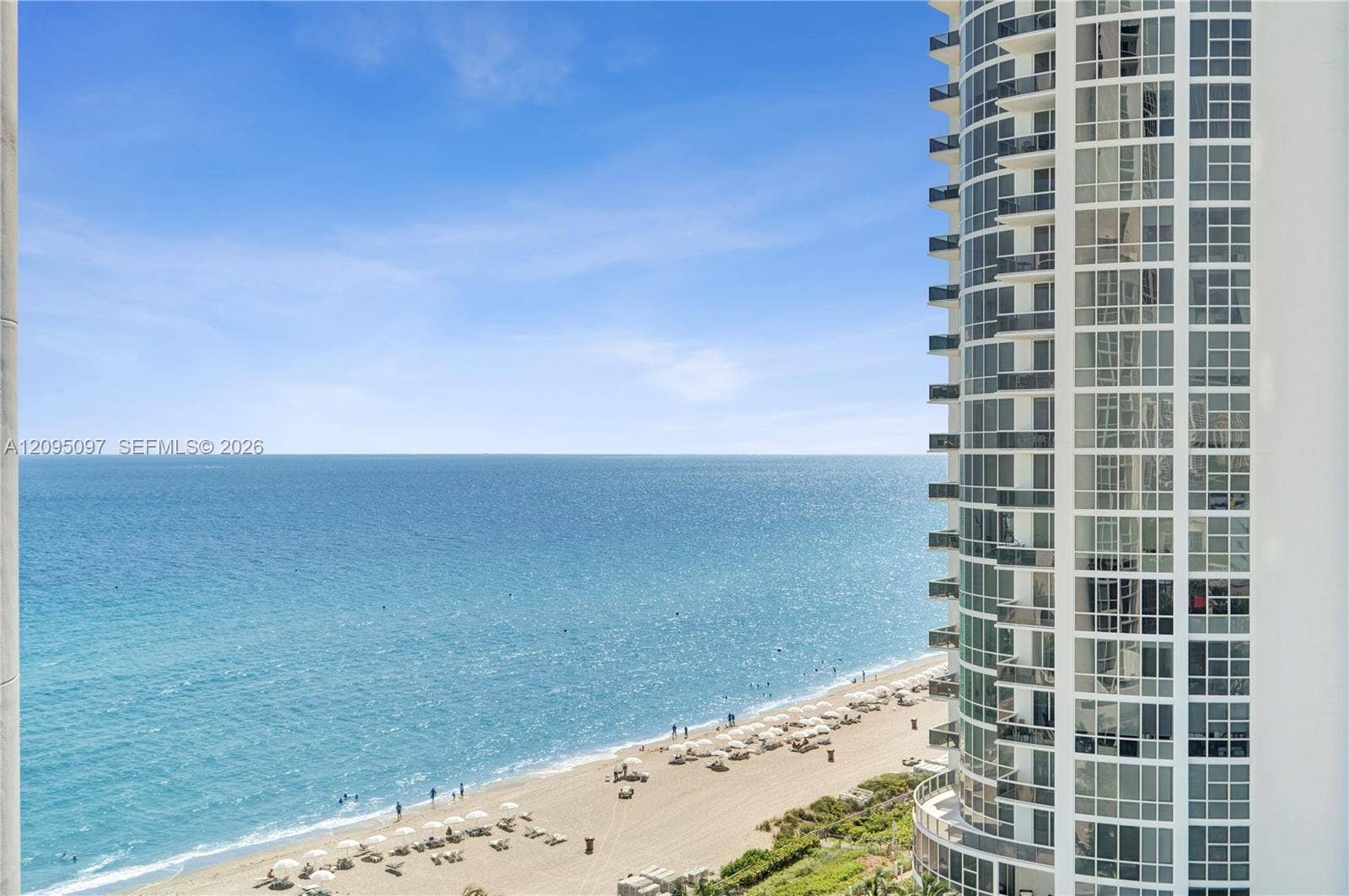 18201 Collins Avenue, #1407, Sunny Isles Beach, FL 33160 High-rise structure featuring floor-to-ceiling glass windows and private balconies overlooking the oceanfront