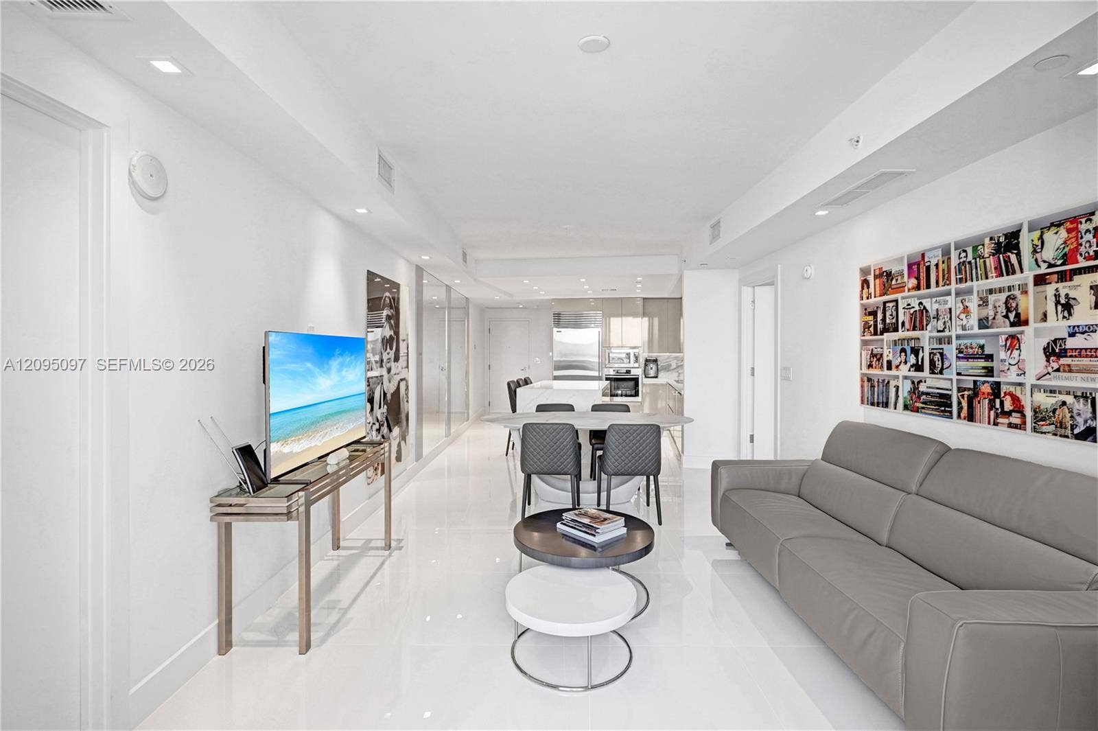 18201 Collins Avenue, #1407, Sunny Isles Beach, FL 33160 Open-concept interior featuring large-format polished tile flooring, recessed ceiling lighting, and custom built-in recessed shelving