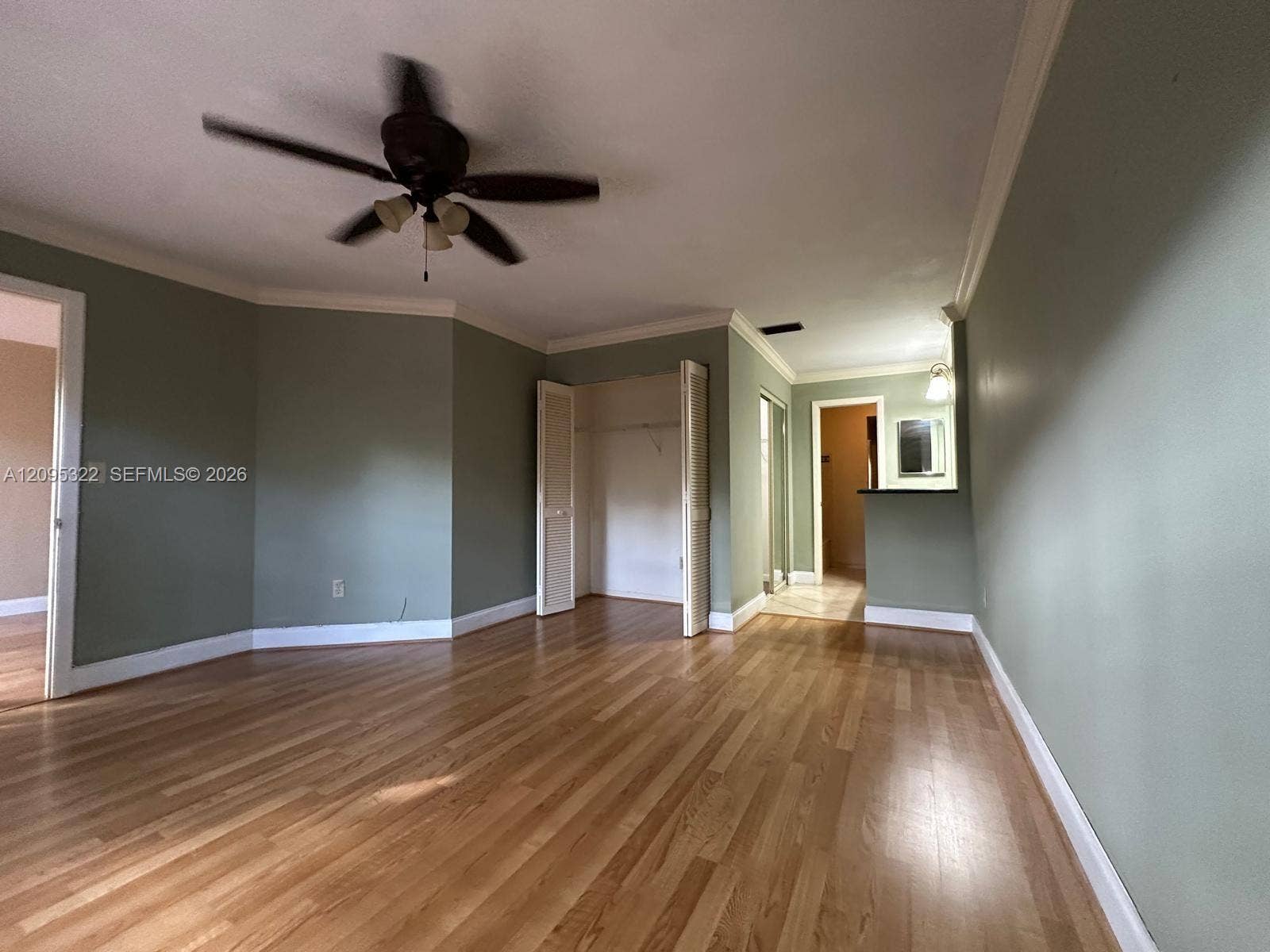 10061 SW 137th Place, Miami, FL 33186 Wood-finish flooring, ceiling fan, crown molding, bi-fold closet doors, and a built-in counter surface