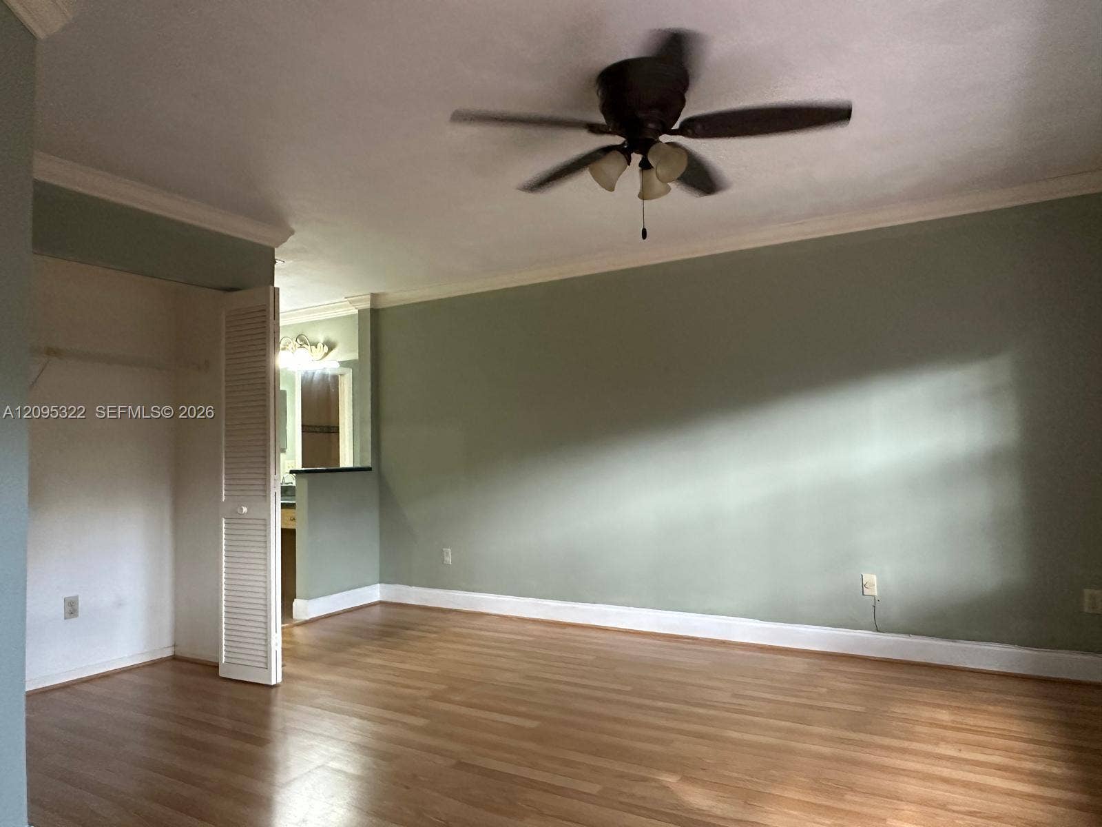 10061 SW 137th Place, Miami, FL 33186 Wood-finish flooring, crown molding, and ceiling fan with integrated lighting