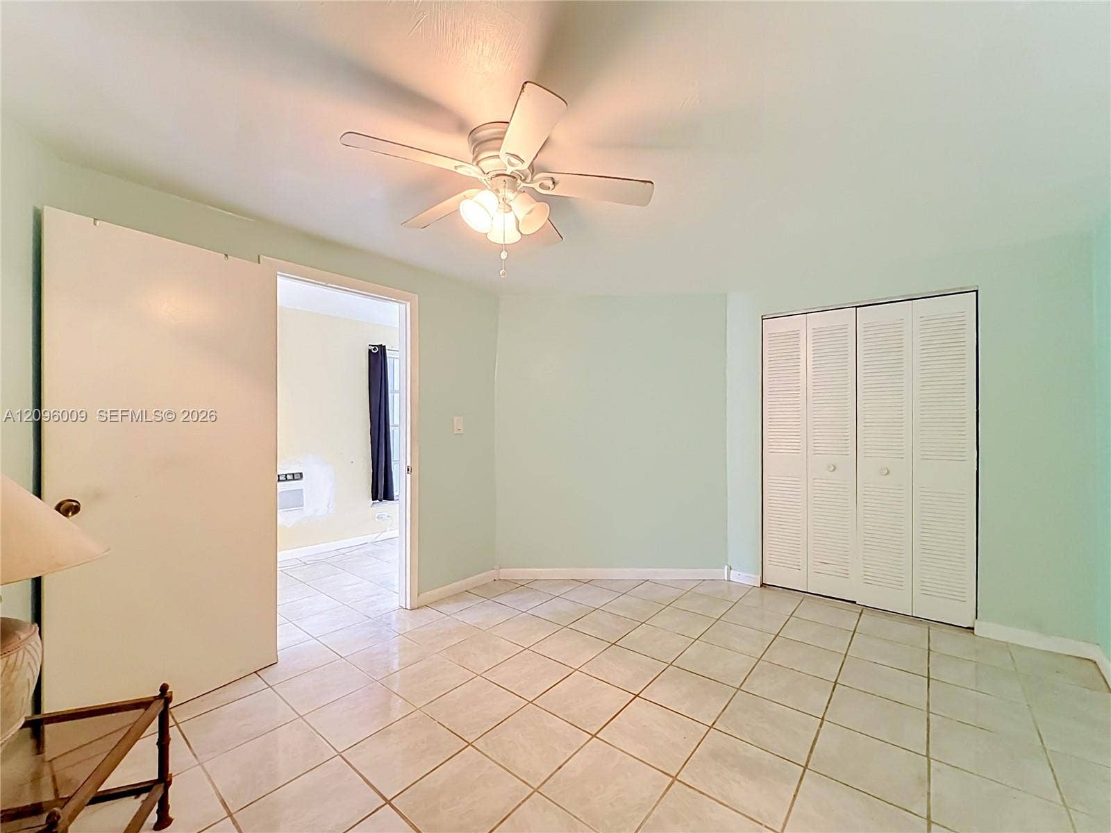 1191 Alabama Avenue, Fort Lauderdale, FL 33312 Tile flooring, light-toned wall paint, white louvered-door closet, and ceiling fan with integrated lighting