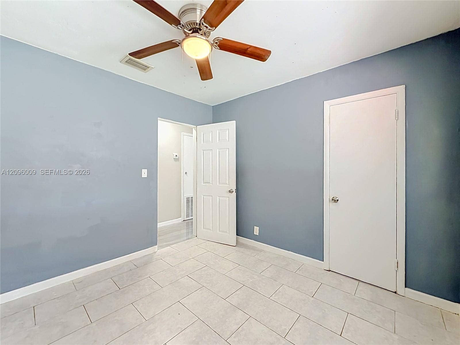 1191 Alabama Avenue, Fort Lauderdale, FL 33312 Interior space featuring ceramic tile flooring, a multi-blade ceiling fan with integrated lighting, and six-panel interior doors