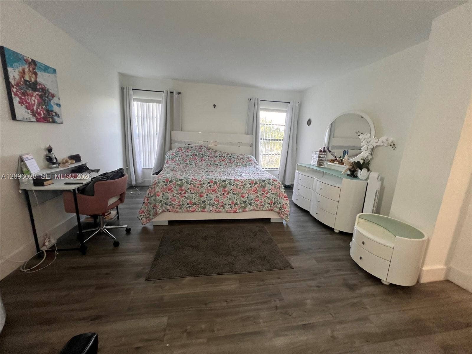 6300 SW 138th Court, #405, Miami, FL 33183 Room featuring wood-finish flooring, two windows, and neutral wall paint