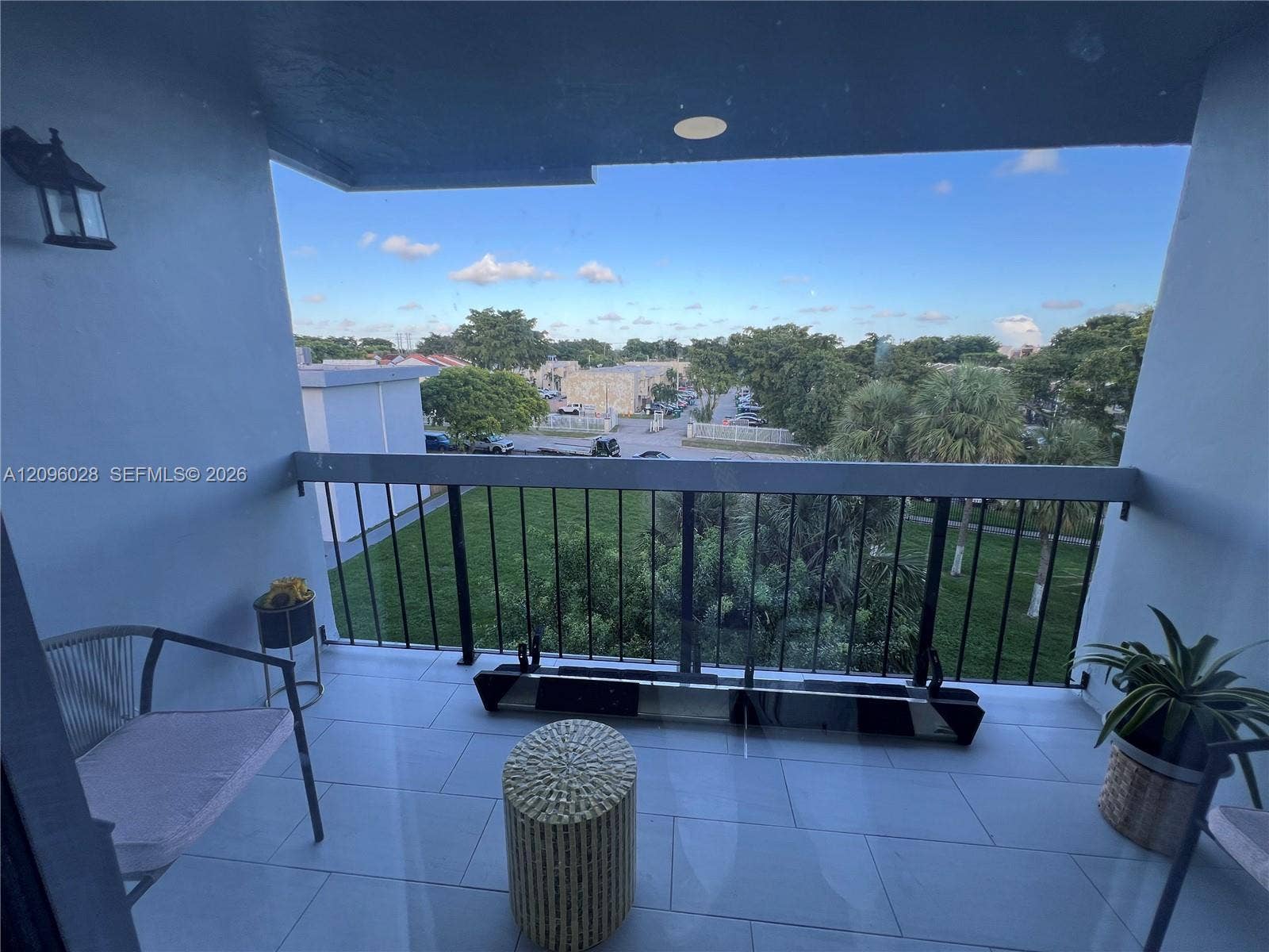 6300 SW 138th Court, #405, Miami, FL 33183 Covered balcony featuring large-format tile flooring, metal railing, and recessed ceiling lighting