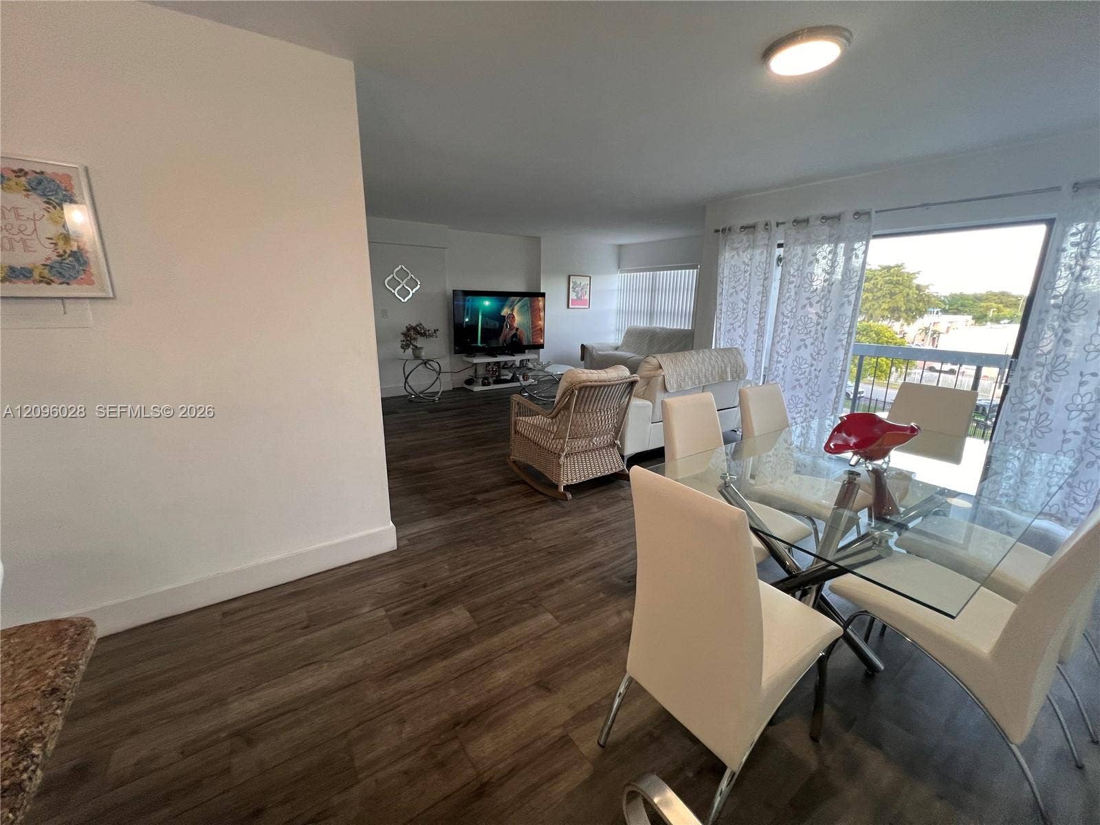 6300 SW 138th Court, #405, Miami, FL 33183 Open-concept interior featuring wood-finish flooring, sliding glass balcony doors, and recessed ceiling lighting