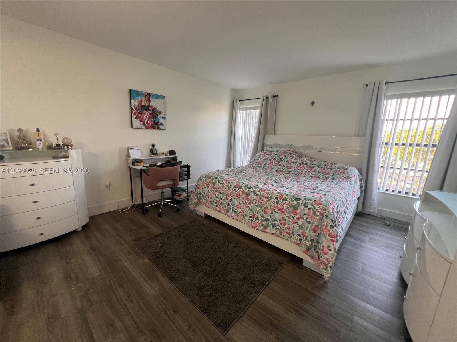 6300 SW 138th Court, #405, Miami, FL 33183 Wood-finish flooring, neutral wall tones, and large windows with vertical blinds