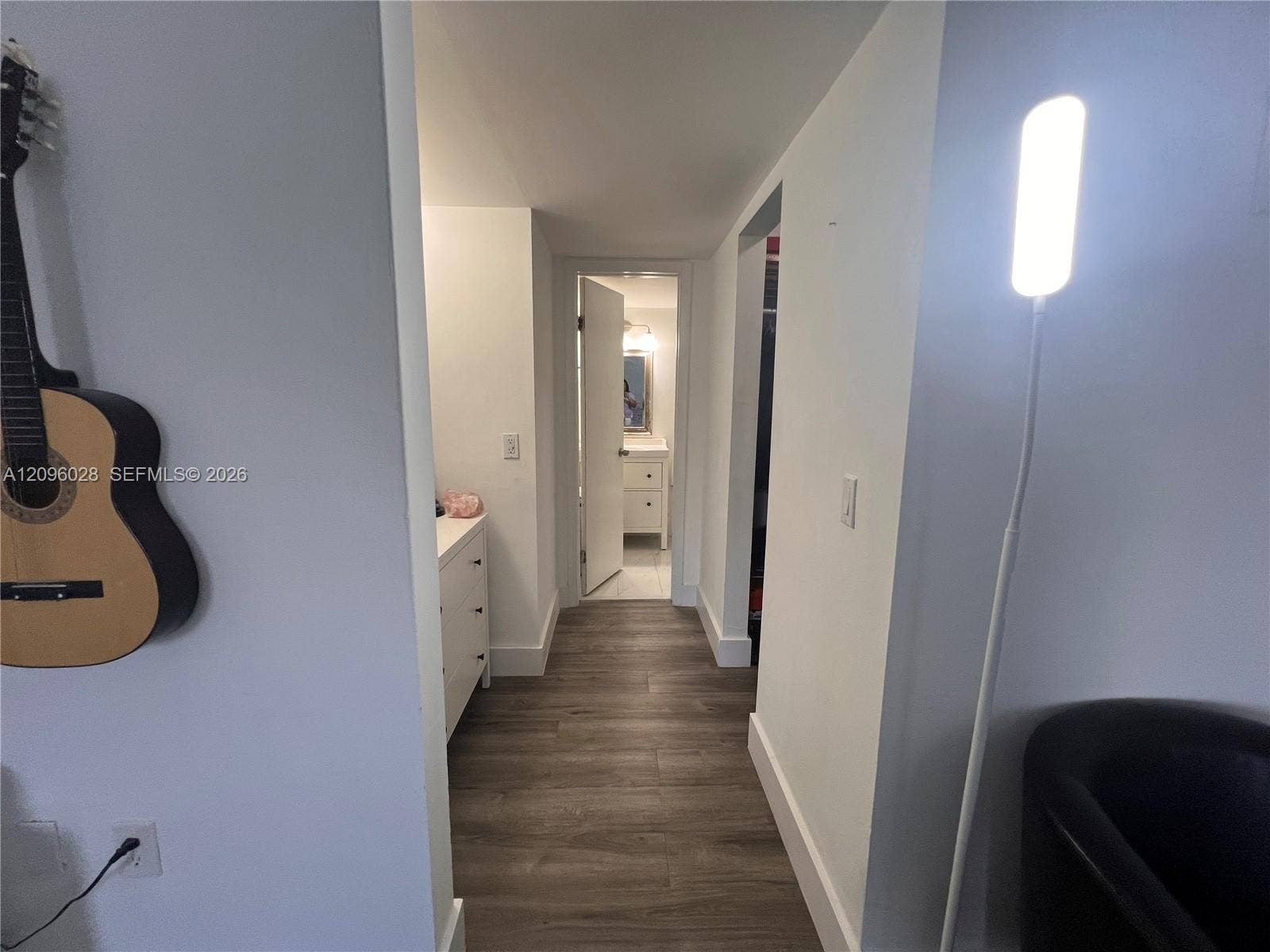 6300 SW 138th Court, #405, Miami, FL 33183 Interior hallway featuring wood-finish flooring and neutral-toned wall paint
