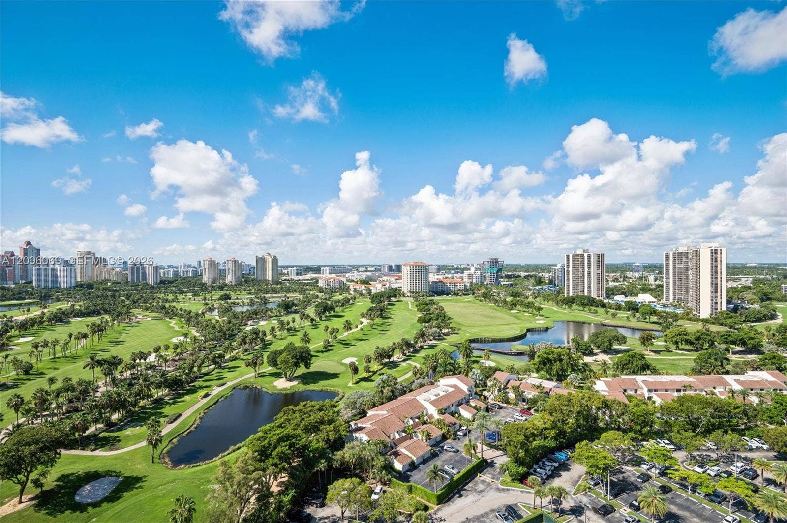 20355 NE 34th Court, #1925, Aventura, FL 33180 Panoramic aerial perspective featuring expansive golf course fairways, mature landscaping, integrated water features, and multi-story structural architecture