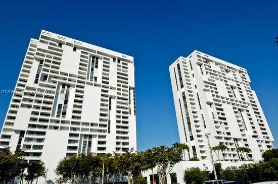 20355 NE 34th Court, #1925, Aventura, FL 33180 High-rise residential towers featuring distinctive grid-patterned white facades, recessed balconies, and vertical architectural detailing