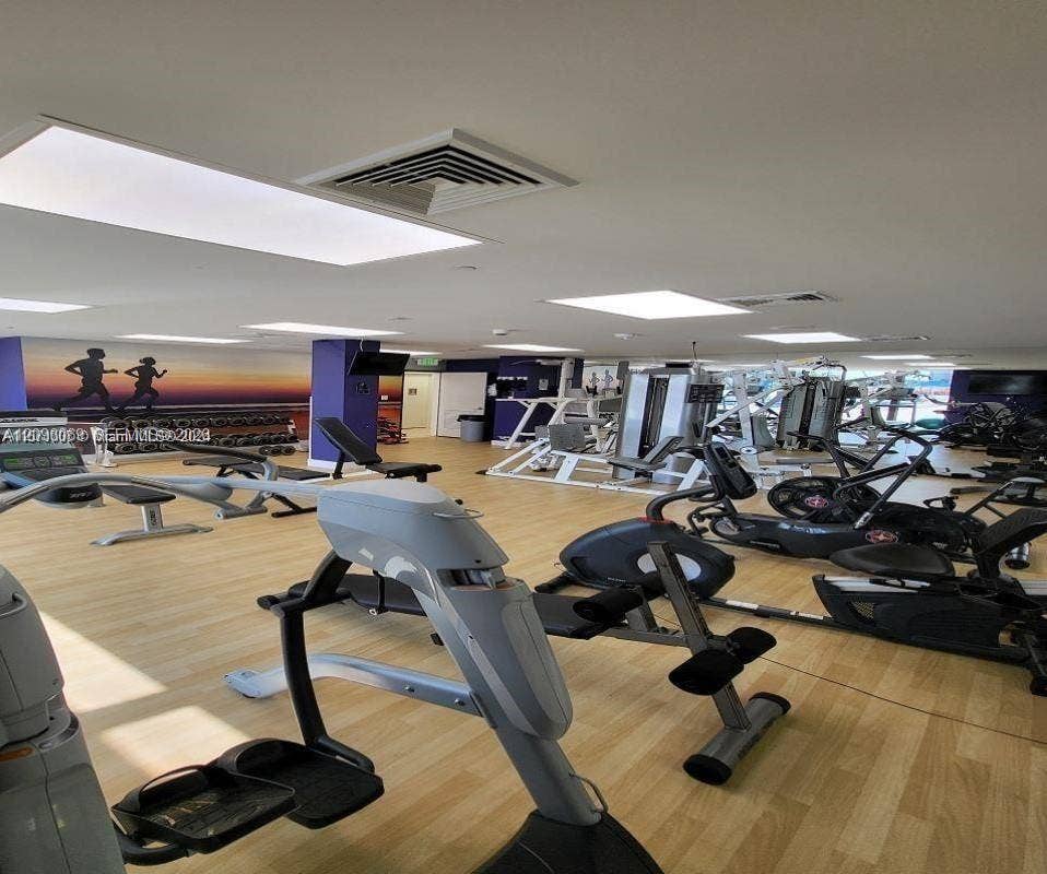 20355 NE 34th Court, #1925, Aventura, FL 33180 Fitness center featuring light-tone wood-finish flooring and recessed lighting panels