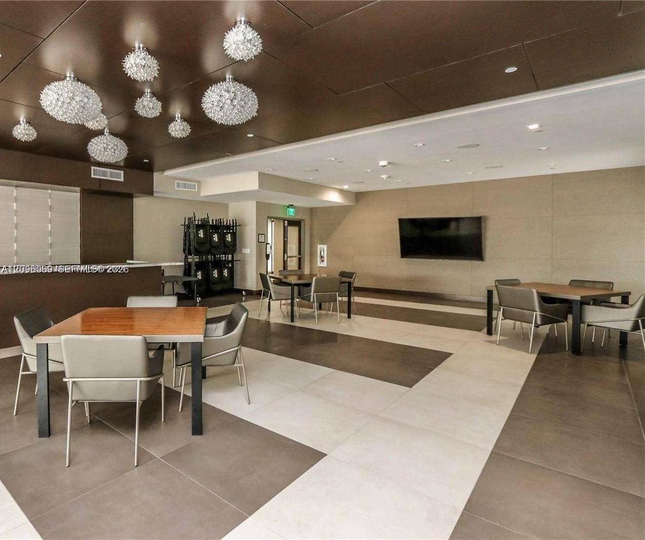 20355 NE 34th Court, #1925, Aventura, FL 33180 Large-format tile flooring, bronze-toned paneled ceiling, and multifaceted glass pendant light fixtures