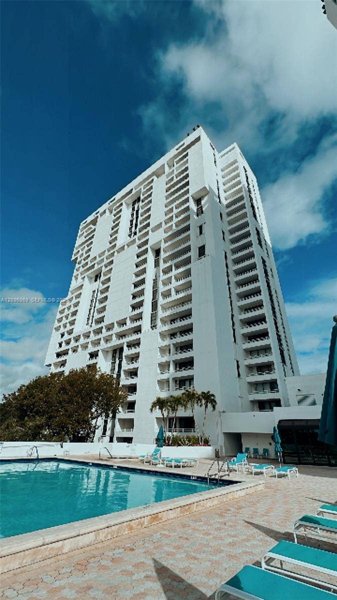 20355 NE 34th Court, #1925, Aventura, FL 33180 High-rise tower featuring tiered balconies and an outdoor swimming pool with paver decking