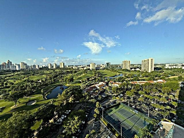 20355 NE 34th Court, #1925, Aventura, FL 33180 Elevated perspective featuring expansive golf course fairways, water hazards, mature trees, and an on-site tennis court