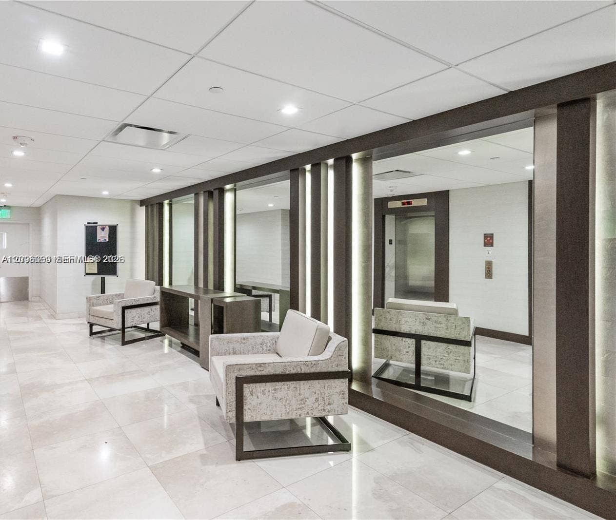 20355 NE 34th Court, #1925, Aventura, FL 33180 Polished stone flooring, floor-to-ceiling mirrors, recessed lighting, and integrated wall-panel accent lighting