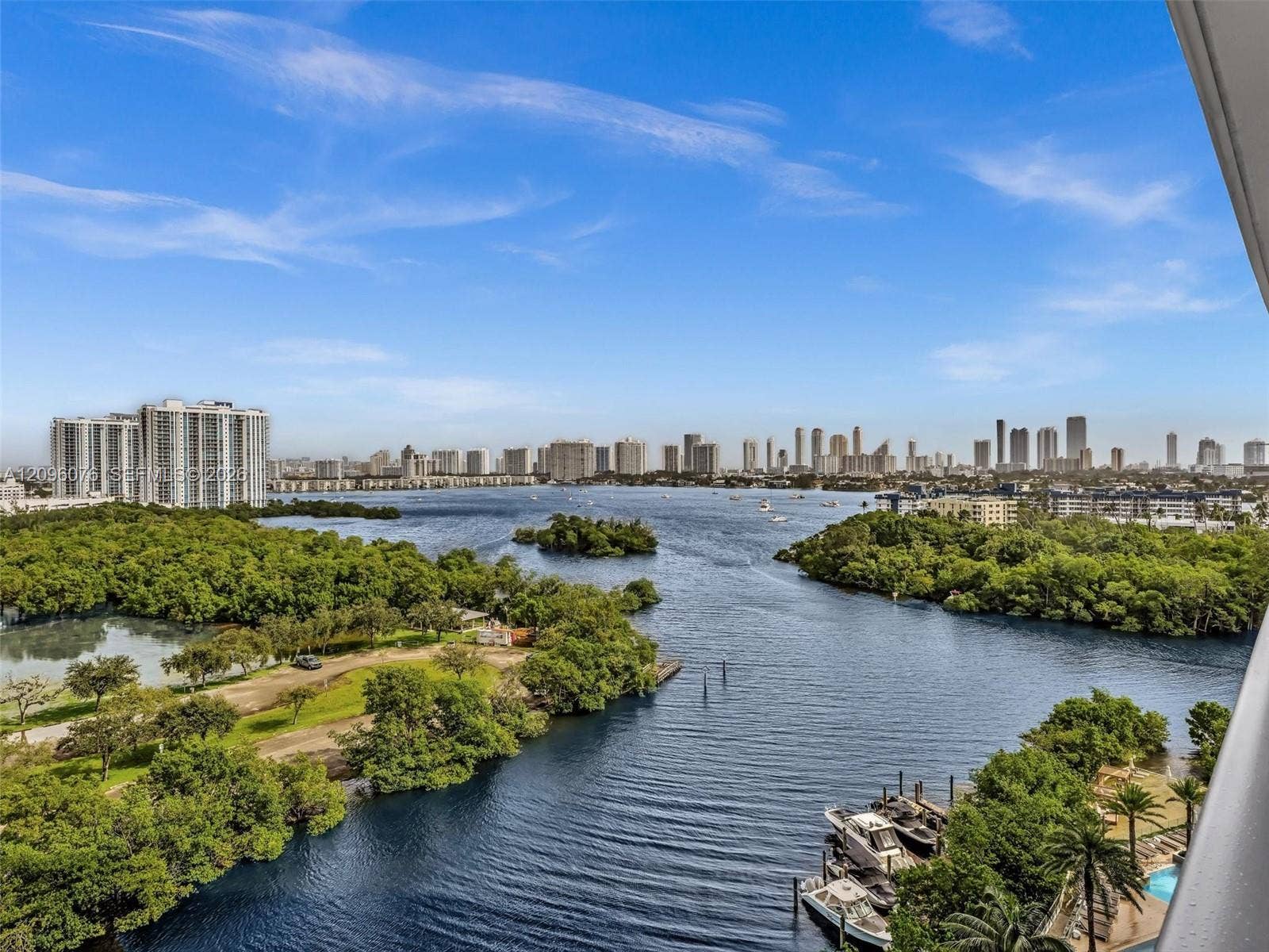 16385 Biscayne Boulevard, #1101, North Miami Beach, FL 33160 Panoramic water, island, and city skyline scenery featuring a waterway, mature vegetation, and multiple boat docks