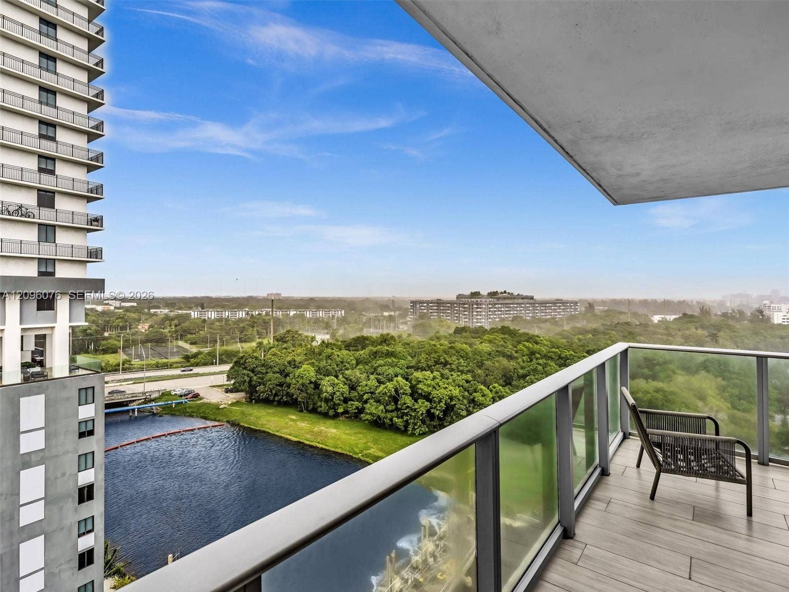 16385 Biscayne Boulevard, #1101, North Miami Beach, FL 33160 Private balcony featuring wood-finish tile flooring and a glass railing