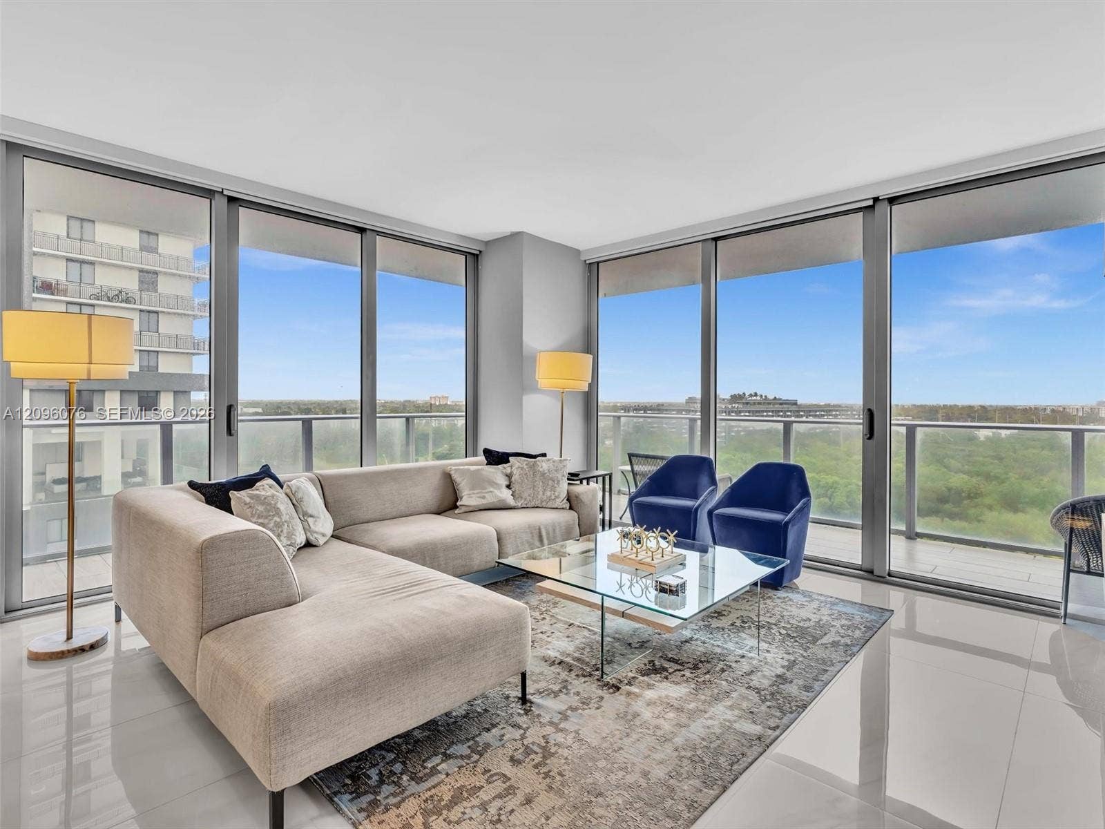 16385 Biscayne Boulevard, #1101, North Miami Beach, FL 33160 Floor-to-ceiling windows, polished tile flooring, and a wrap-around balcony with metal railing