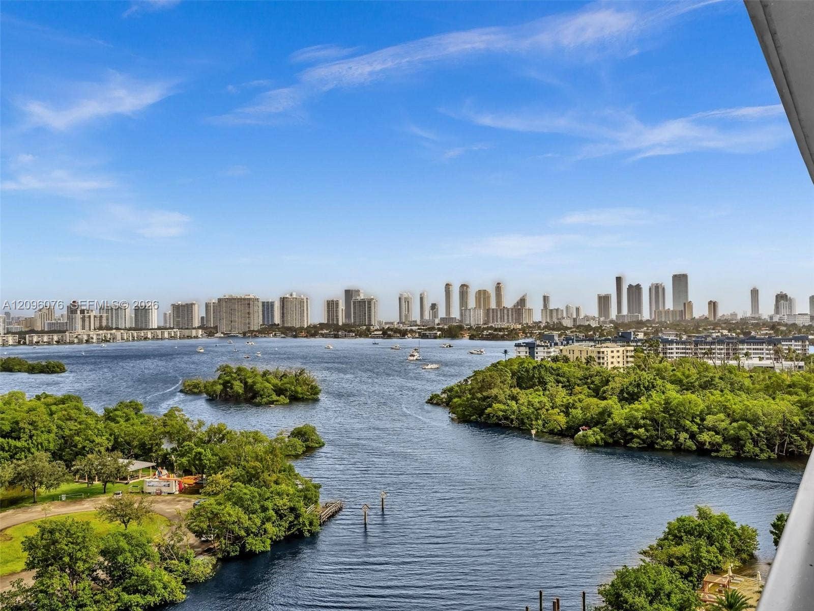 16385 Biscayne Boulevard, #1101, North Miami Beach, FL 33160 Panoramic skyline and expansive water scenery featuring a wide waterway, coastal vegetation, and urban high-rise buildings
