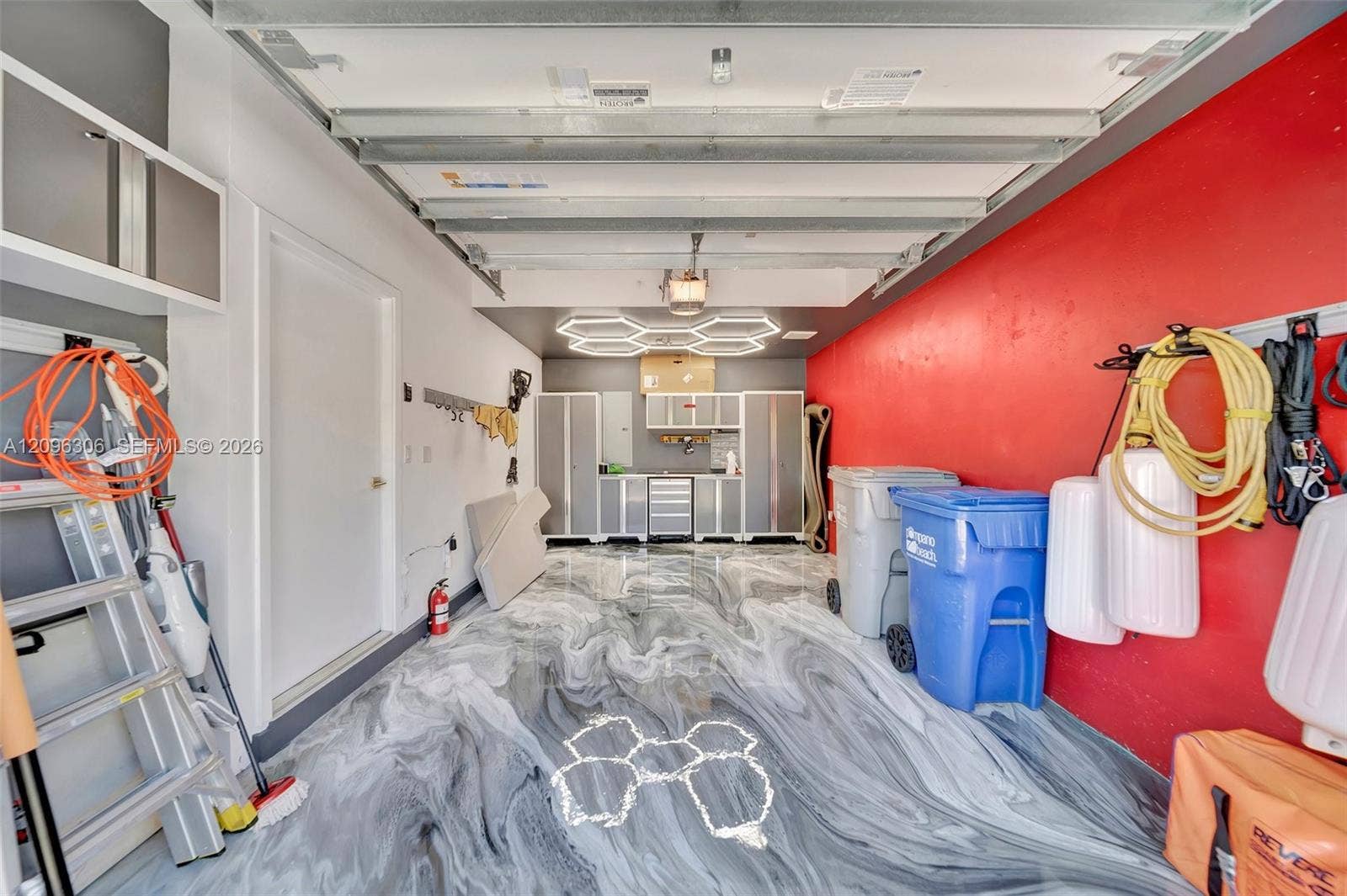 508 SE 1st Circle, Pompano Beach, FL 33060 Garage with custom epoxy flooring and lighting - door to left leads into the foyer