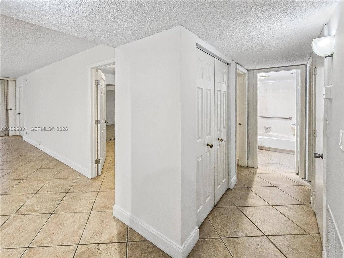 1830 Sabal Palm Drive, #105, Davie, FL 33324 Neutral-toned ceramic tile flooring, built-in double-door closet, and six-panel interior doors