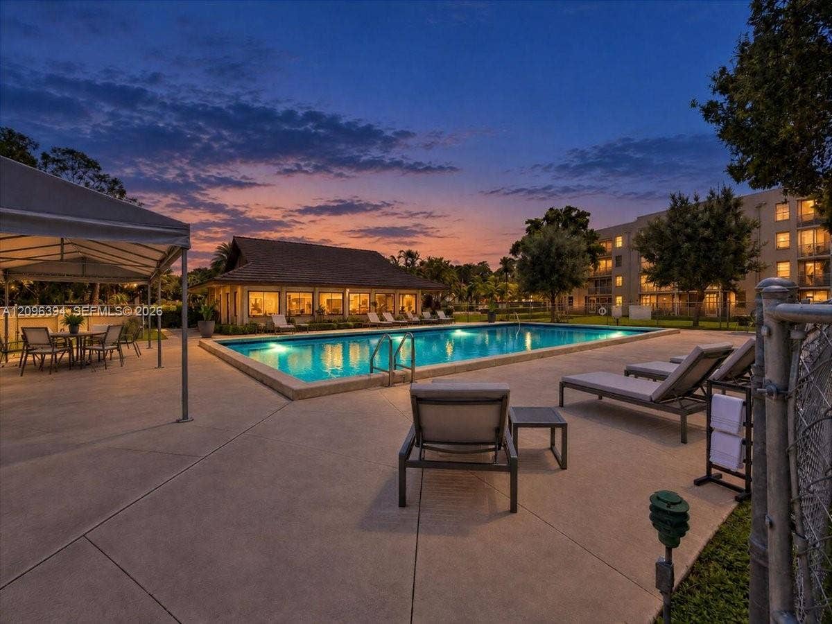 1830 Sabal Palm Drive, #105, Davie, FL 33324 Outdoor swimming pool featuring a concrete deck, covered pavilion, and metal perimeter fencing