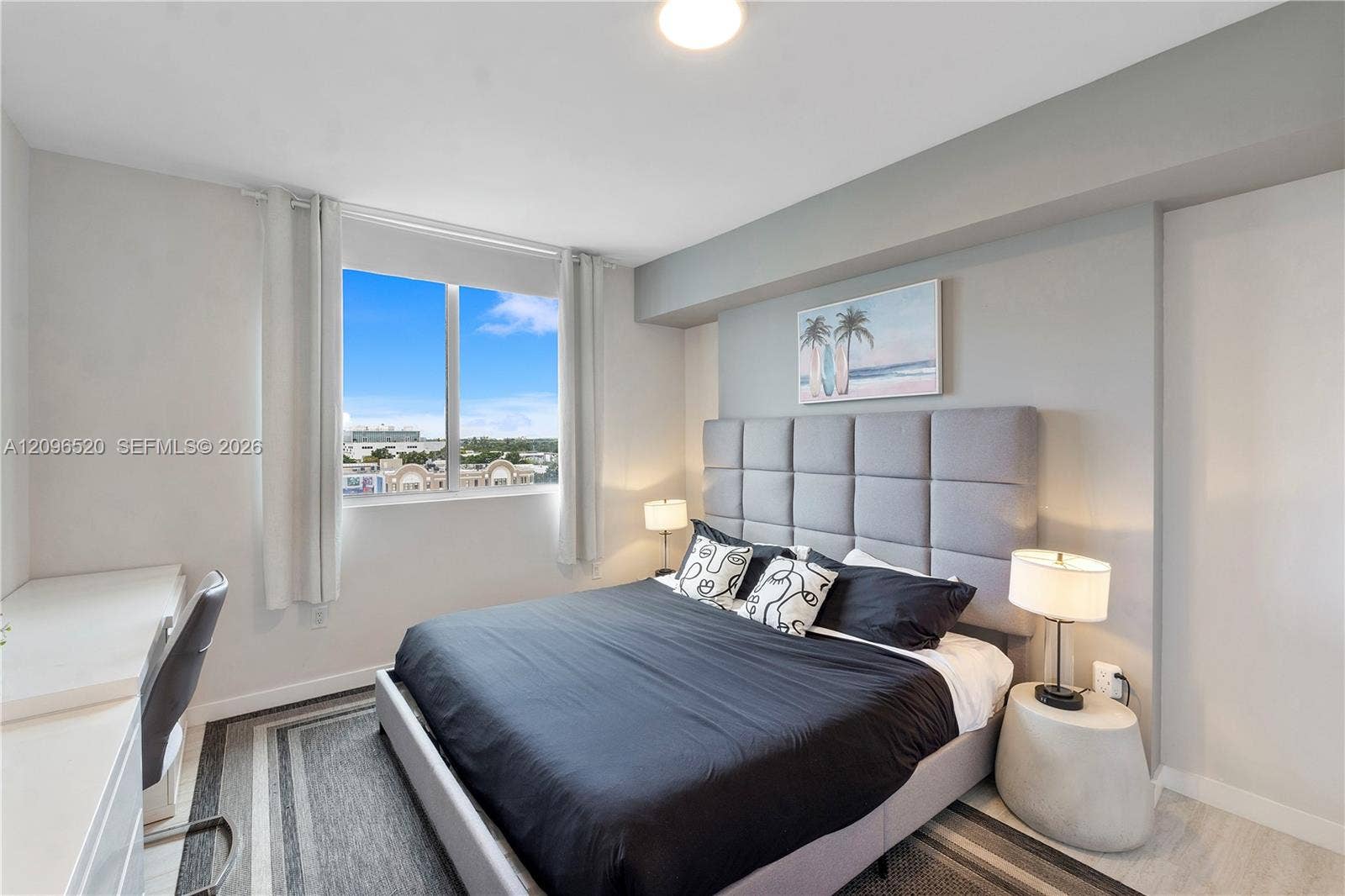 Bedroom featuring neutral-toned walls, wood-finish flooring, a large window, and recessed ceiling lighting