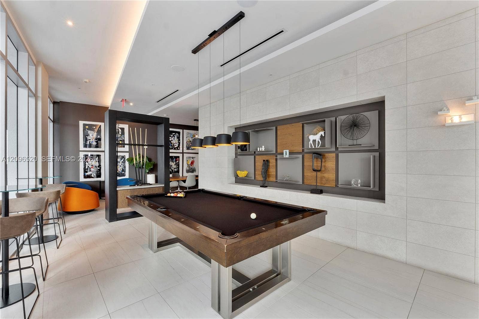 Large format tile flooring, built-in recessed shelving with wood and matte finishes, suspended linear lighting, and ceiling-height windows