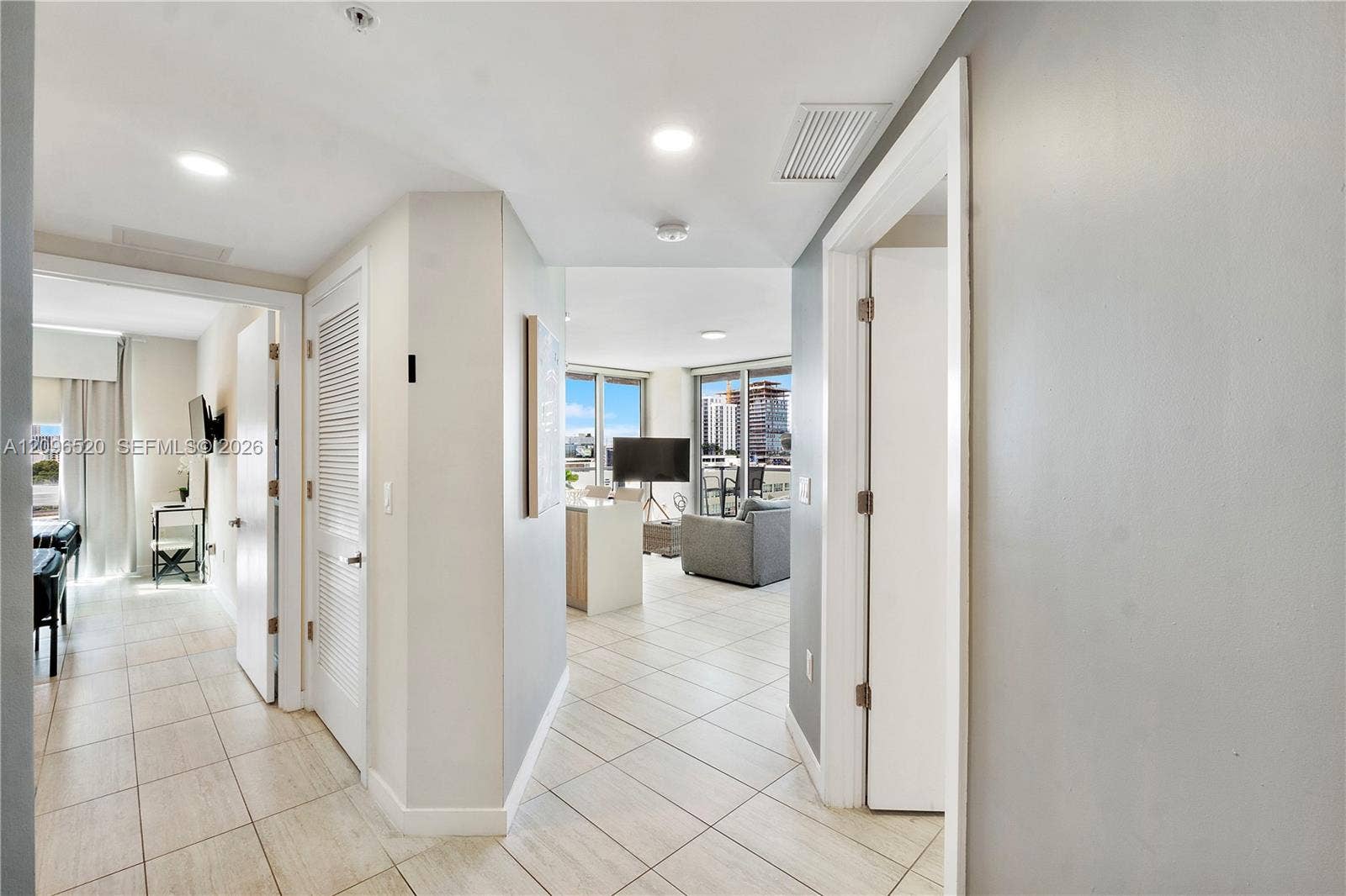 Ceramic tile flooring, recessed lighting, and expansive floor-to-ceiling windows
