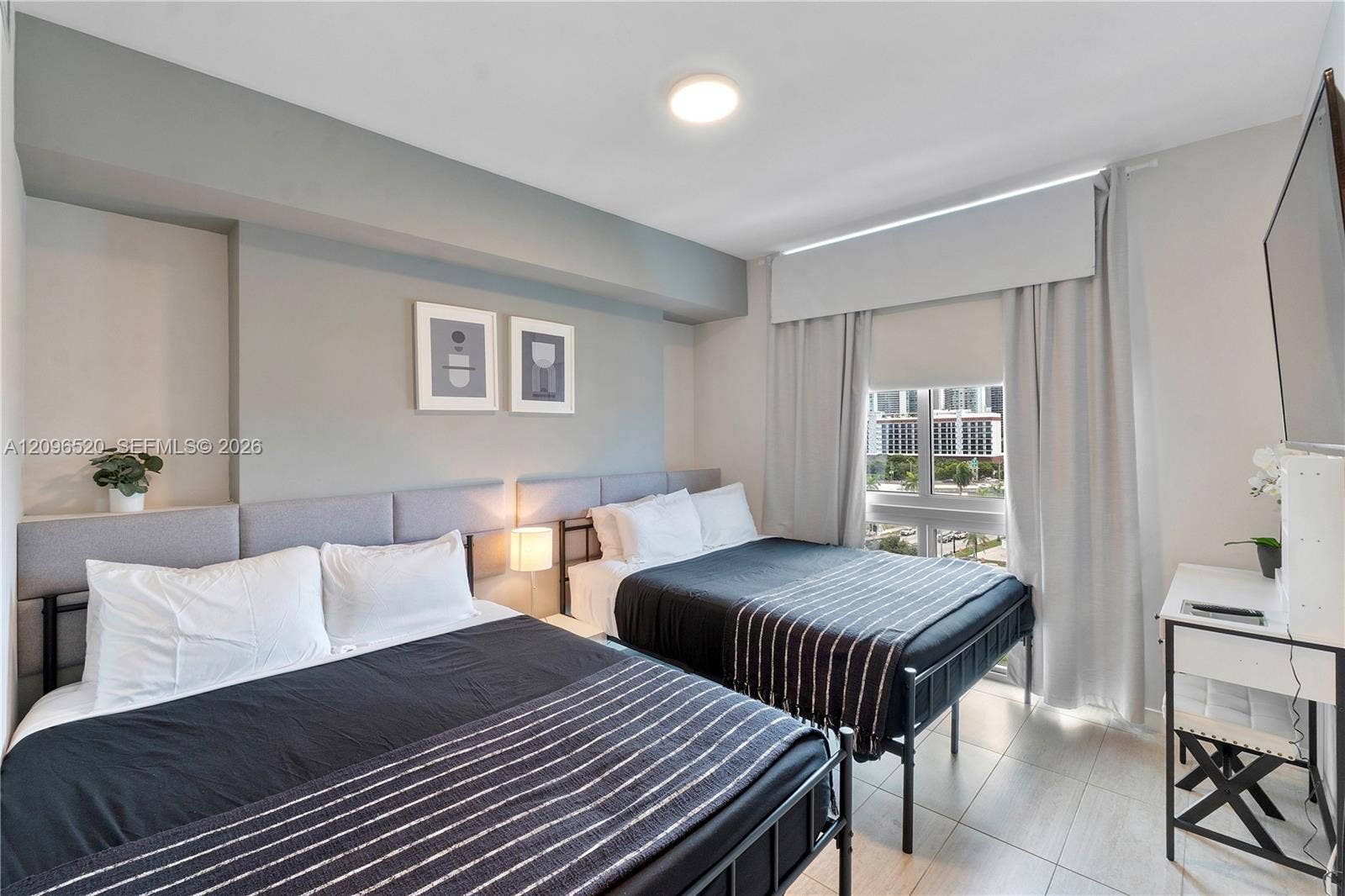 Bedroom featuring neutral wall tones, tile flooring, recessed ceiling lighting, and a window with a valance