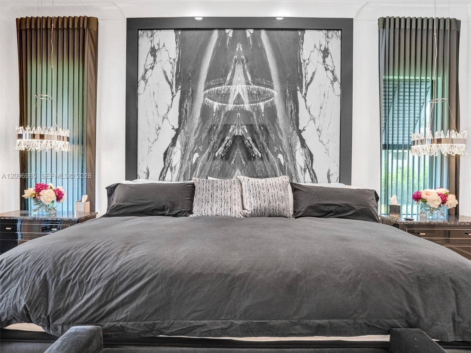 10157 SE Sandpine Lane, Hobe Sound, FL 33455 Floor-to-ceiling stone slab focal wall, two crystal-accented pendant light fixtures, and dual built-in side cabinets with stone tops