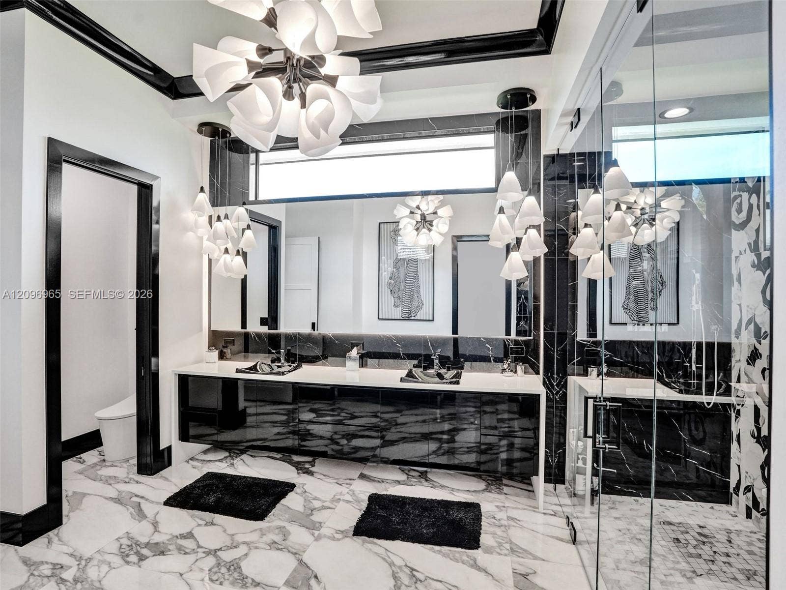 10157 SE Sandpine Lane, Hobe Sound, FL 33455 Floating vanity with integrated sinks, floor-to-ceiling mirror, high-gloss cabinetry, multi-pendant lighting, and large-format tile flooring