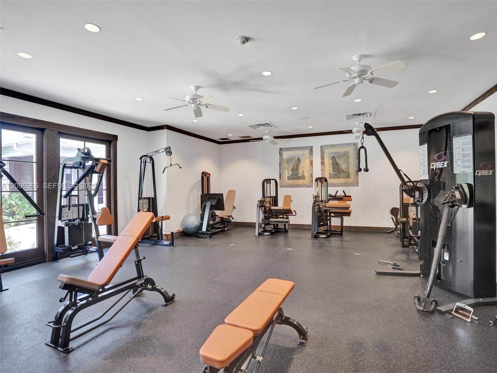 10157 SE Sandpine Lane, Hobe Sound, FL 33455 Fitness space featuring rubberized flooring, recessed lighting, white ceiling fans, and glass-paneled double doors